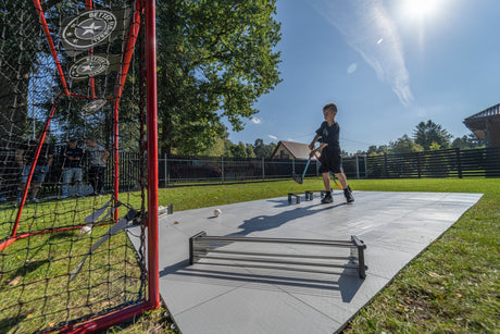 Kids training floorball at home in the yard