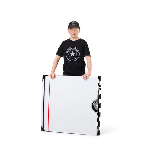 Young hockey player practicing stickhandling on the Game Changer training board in hockey gear
