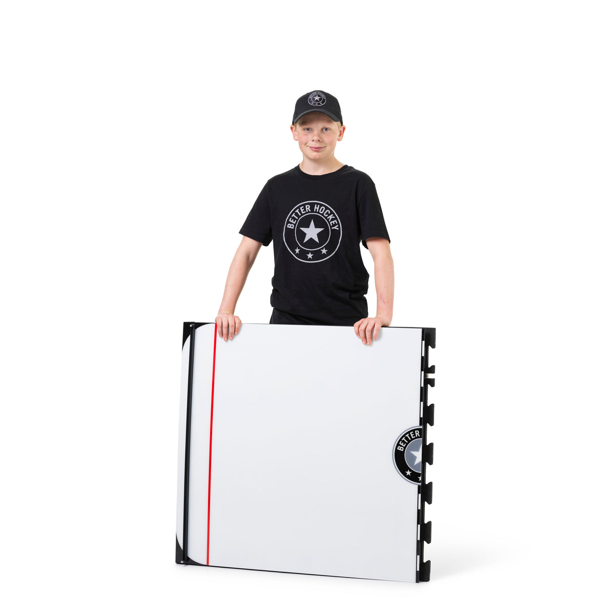 Young hockey player holding a Game Changer training board in a gym setting