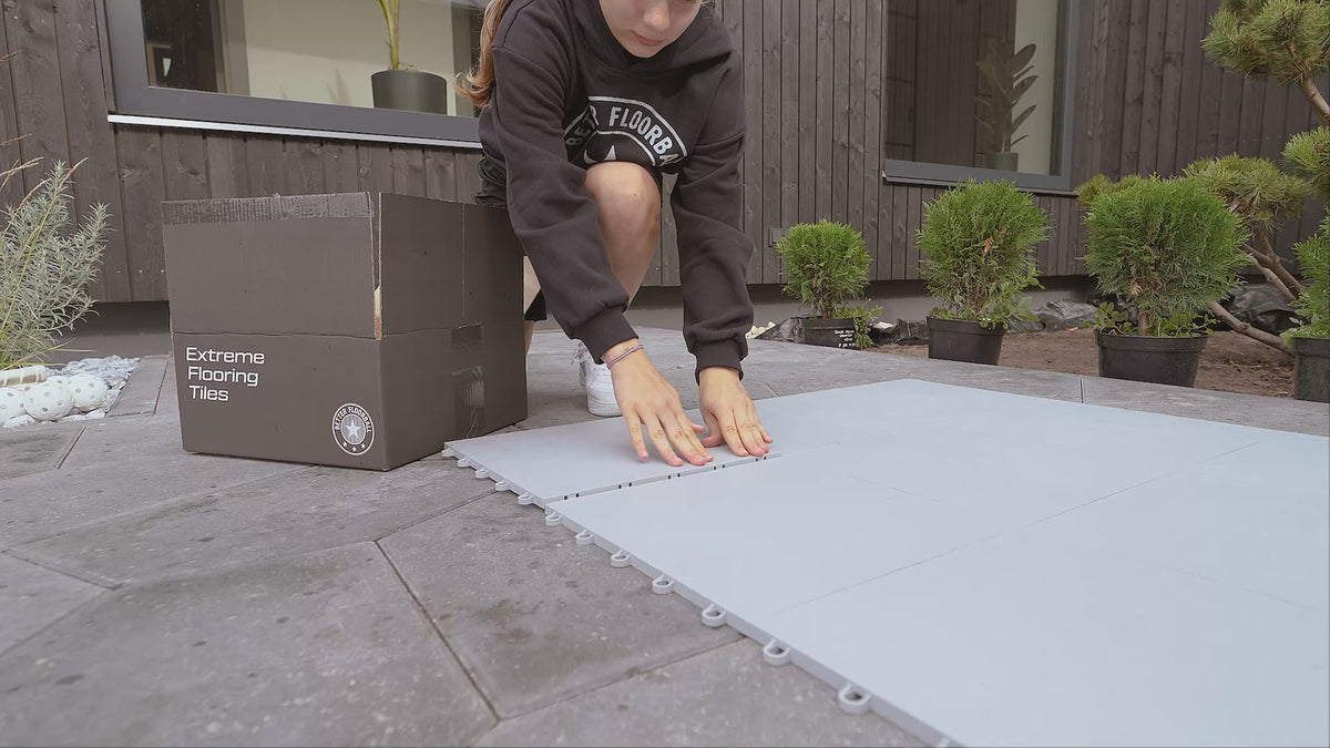 Floorball tiles being laid on the patio